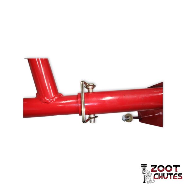 parachute quick release from the mount receiver in the color red. Logo of a dog in a zoot-suit in front of drag strip lighting text that says,"Zoot Chutes".