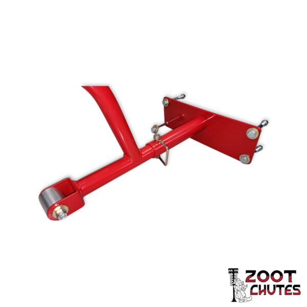 Parachute mount assembly, showing the mounting apparatus, quick release pin and chord busing in the color red. Logo of a dog in a zoot-suit in front of drag strip lighting text that says,"Zoot Chutes".